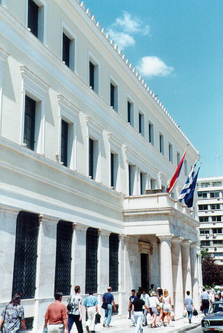 Athens City Hall marble propylon - Three-storied building of austere morphological elements. The marble propylon at the entrance is one of the characteristic elements of the building while the ground floor is also covered with marble and the openings in between are filled with decorating