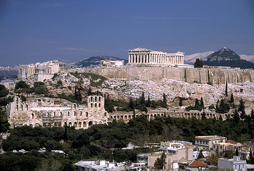 View of the Acropolis and the South Slope from the southwest (from near the Philopappos Monument). - In the background to the right of the Parthenon are Mt. Lykabettos and Mt. Penteli. Photo taken in 1998.
